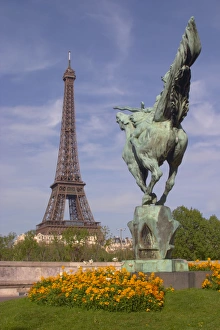 The Eiffel Tower in Paris with a statue of a horse seen from behind in the foreground The Eiffel Tower in Paris with a statue of a horse seen from behind in the foreground