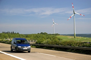 Electricity wind generators and automobiles traveling on the autobahn in northwest Electricity wind generators and automobiles traveling on the autobahn in northwest