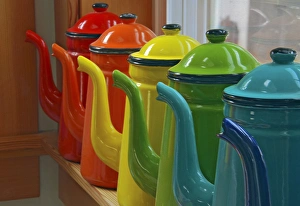 Enamelware coffee pots in orderly row on window sill Enamelware coffee pots in orderly row on window sill