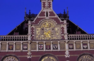 EU, Netherlands, Amsterdam. Central Station, red brick building with ornate gold EU, Netherlands, Amsterdam. Central Station, red brick building with ornate gold