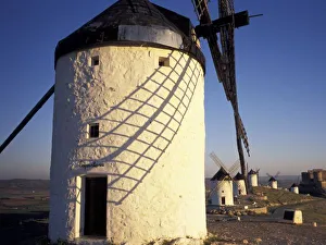 EU, Spain, Consuegro, La Mancha. Windmills and castle in the distance EU, Spain, Consuegro, La Mancha. Windmills and castle in the distance