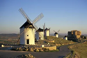 EU, Spain, La Mancha, Consuegra. Windmills and castle in the background EU, Spain, La Mancha, Consuegra. Windmills and castle in the background