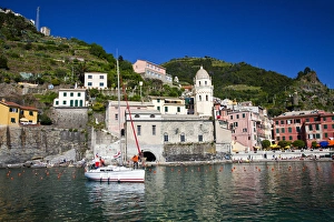 Europe; Italy; Vernazza; Sail Boat landing at the City and Church of Santa Margherita Europe; Italy; Vernazza; Sail Boat landing at the City and Church of Santa Margherita