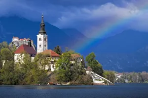 Europe, Slovenia, Lake Bled. Rainbow over lake and church Europe, Slovenia, Lake Bled. Rainbow over lake and church