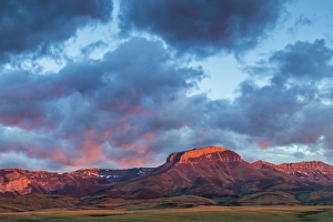 Fiery sunrise light strikes Ear Mountain along the Rocky Mountain Front near Choteau Fiery sunrise light strikes Ear Mountain along the Rocky Mountain Front near Choteau