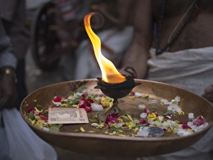 A fire burns in a golden bowl in Bangalore, Karnataka, India A fire burns in a golden bowl in Bangalore, Karnataka, India