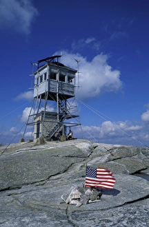 The fire tower on the summit of Mt. Cardigan in Mt. Cardigan State Park. American flag The fire tower on the summit of Mt. Cardigan in Mt. Cardigan State Park. American flag