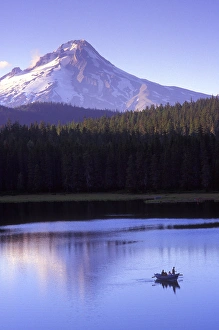 Fishermen in drift boat on Frog Lake sunset with Mt. Hood towering in the background Fishermen in drift boat on Frog Lake sunset with Mt. Hood towering in the background