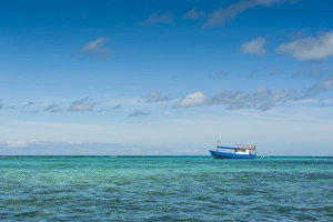 Fishing boat in the turquoise waters of the blue lagoon, Yasawas, Fiji, South Pacific Fishing boat in the turquoise waters of the blue lagoon, Yasawas, Fiji, South Pacific