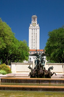 A fountain on the campus of University of Texas in Austin with the clock tower in A fountain on the campus of University of Texas in Austin with the clock tower in