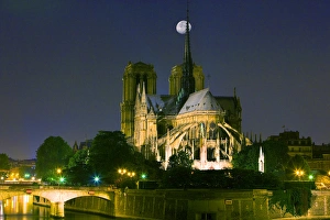 France, Paris. Full moon over Notre Dame Cathedral at night France, Paris. Full moon over Notre Dame Cathedral at night