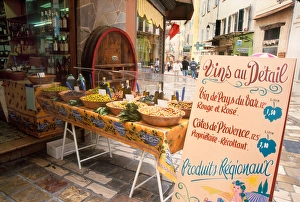 France, Riviera, Hyeres - Olive and wine display with sign advertising local wine France, Riviera, Hyeres - Olive and wine display with sign advertising local wine