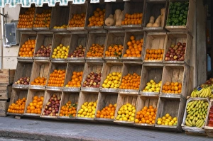 A fruit and vegetable shop displaying products in wooden crates on the street: tomatoes A fruit and vegetable shop displaying products in wooden crates on the street: tomatoes