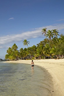 Girl walking along beach, Plantation Island Resort, Malolo Lailai Island, Mamanuca Islands Girl walking along beach, Plantation Island Resort, Malolo Lailai Island, Mamanuca Islands