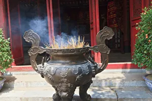 Hanoi, Vietnam. Incense offering at Ngoc Son Pagoda (Temple of the Jade Mound), a Hanoi, Vietnam. Incense offering at Ngoc Son Pagoda (Temple of the Jade Mound), a