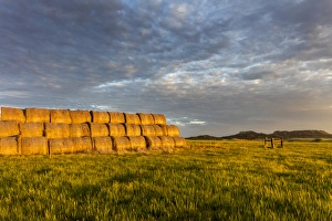 Hay bales and Chalk Buttes receive beautiful morning light near Ekalaka, Montana, USA Hay bales and Chalk Buttes receive beautiful morning light near Ekalaka, Montana, USA