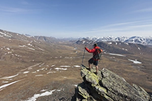 A hiker looks across the upper Nigu River Valley in Gates of the Arctic National Park and Preserve A hiker looks across the upper Nigu River Valley in Gates of the Arctic National Park and Preserve
