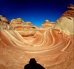 Hiker in the Wind and water eroded Navajo sandstone in Coyote Buttes North, Paria Hiker in the Wind and water eroded Navajo sandstone in Coyote Buttes North, Paria
