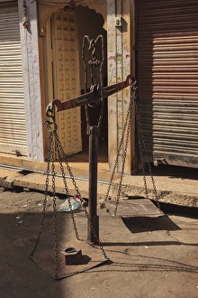 India, Rajasthan, Jaisalmer. Scales in front of shop India, Rajasthan, Jaisalmer. Scales in front of shop