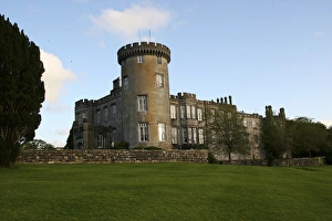 In Ireland, the Dromoland Castle turret grounds and green lawn with blue sky white clouds In Ireland, the Dromoland Castle turret grounds and green lawn with blue sky white clouds