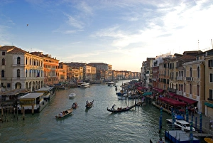 Italy; Venice. The bustling riverfront along the Grand Canal in Venice at sunrise Italy; Venice. The bustling riverfront along the Grand Canal in Venice at sunrise