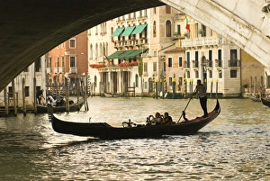 Italy; Venice. Tourist take snap shots from a gondola as they pass under the Rialto Italy; Venice. Tourist take snap shots from a gondola as they pass under the Rialto