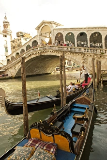 Italy; Venice. Tourists ride in gondolas on the Grand Canal near the Rialto Bridge Italy; Venice. Tourists ride in gondolas on the Grand Canal near the Rialto Bridge