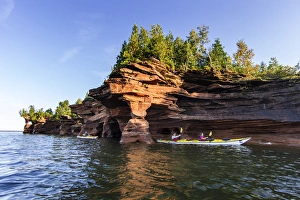 Kayakers exploring the sea caves of Devils Island in the Apostle Islands National Lakeshore Kayakers exploring the sea caves of Devils Island in the Apostle Islands National Lakeshore