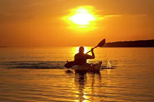 Kayaking at sunset in the Apostle Islands National Lakeshore of Lake Superior near Bayfield Kayaking at sunset in the Apostle Islands National Lakeshore of Lake Superior near Bayfield