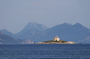 A lighthouse light house on an island outside the village A lighthouse light house on an island outside the village