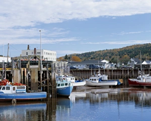 Lobster boats tied up to dock at low tide in Alma, along the Bay of Fundy coast of New Lobster boats tied up to dock at low tide in Alma, along the Bay of Fundy coast of New