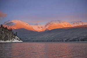 Looking toward Rocky Point the peaks catch alpenglow and reflect into Lake McDonald Looking toward Rocky Point the peaks catch alpenglow and reflect into Lake McDonald