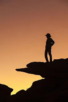 Man standing on rock surveying the view. (MR) Man standing on rock surveying the view. (MR)