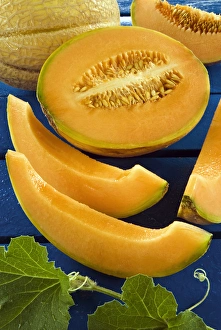 Whole melon and one cut into pieces (Cucumis melo) Whole melon and one cut into pieces (Cucumis melo)