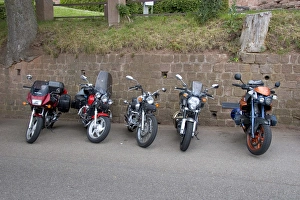 Motorcycles parked along a rock wall in Eastern France. france, french, europe Motorcycles parked along a rock wall in Eastern France. france, french, europe