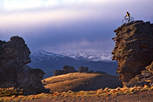 Mountain Biker on Rock Tor, Duffers Saddle, Carrick Range, Central Otago Mountain Biker on Rock Tor, Duffers Saddle, Carrick Range, Central Otago