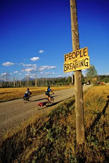 Mountain bikers head into Polebridge while riding on the Great Divide Route in Montana Mountain bikers head into Polebridge while riding on the Great Divide Route in Montana