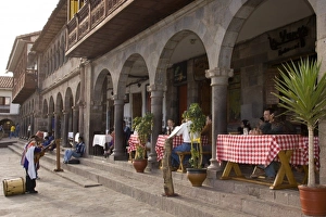 Musician playing for tourists having lunch on patio, Plaza de Armas, Cuzco, Peru Musician playing for tourists having lunch on patio, Plaza de Armas, Cuzco, Peru