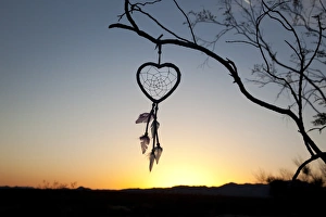 Native American heart shaped dreamcatcher at early morning sunrise Native American heart shaped dreamcatcher at early morning sunrise