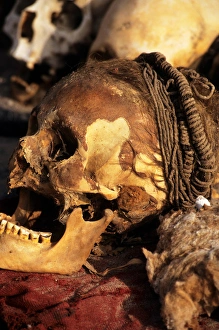 near Nasca, Peru. Skull with braided hair and skin, showing teeth badly worn down near Nasca, Peru. Skull with braided hair and skin, showing teeth badly worn down