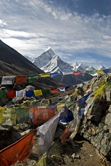 Nepal. Prayer flags are hung along the Everest Base Camp Trail with the peak of Ama Nepal. Prayer flags are hung along the Everest Base Camp Trail with the peak of Ama