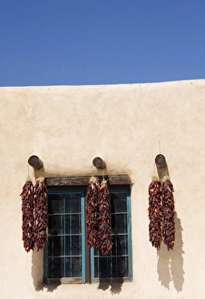 NM, New Mexico, Taos, shop fronts at Taos Plaza, with chile ristras NM, New Mexico, Taos, shop fronts at Taos Plaza, with chile ristras
