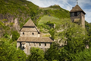 An old castle ruin in Northern Italy situated on a steep hillside An old castle ruin in Northern Italy situated on a steep hillside