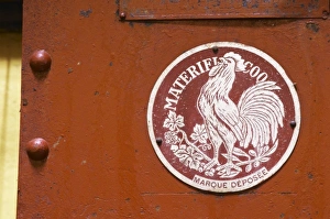 Old red wine press with a sign Materiel Coq with a French cock symbol Domaine la Tourade Old red wine press with a sign Materiel Coq with a French cock symbol Domaine la Tourade