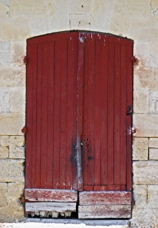 An old red wooden door on one of the winery buildings Chateau Kirwan, Cantenac Margaux An old red wooden door on one of the winery buildings Chateau Kirwan, Cantenac Margaux