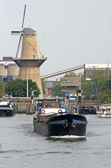 Old windmill and boats in the harbor at Rotterdam, Netherlands Old windmill and boats in the harbor at Rotterdam, Netherlands