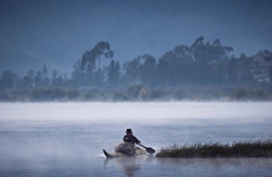 Otavalo Indian Fisherman using Tradition Reed Boat, Lake San Pablo near Otavalo, Andes Otavalo Indian Fisherman using Tradition Reed Boat, Lake San Pablo near Otavalo, Andes