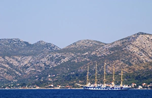 The Peljesac peninsula and Sveti Ilija mountain with a big sailing cruise ship schooner The Peljesac peninsula and Sveti Ilija mountain with a big sailing cruise ship schooner