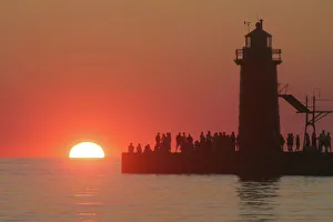 People lighthouse sunset silhouette at South Haven Michigan People lighthouse sunset silhouette at South Haven Michigan