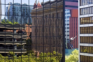Portlandia sculpture seen between buildings reflected in buildings in downtown Portland Portlandia sculpture seen between buildings reflected in buildings in downtown Portland